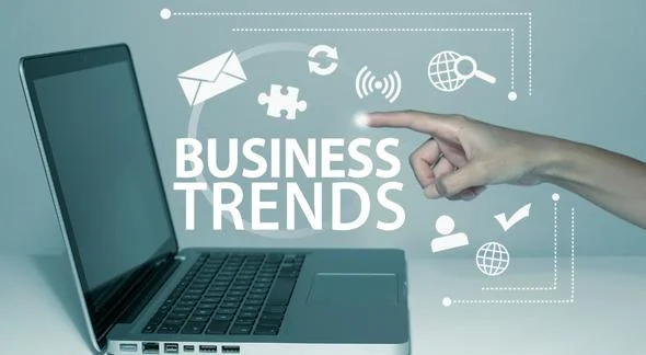someone pointing on laptop with a word business trend